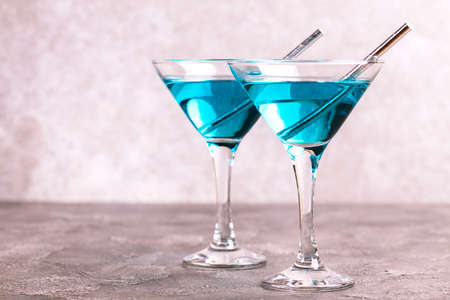 Two glasses of trendy blue wine with paper straws. Spanish blue wine chardonnay on dark concrete background. Romantic dateの写真素材