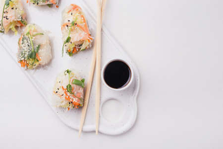 Fresh assorted Vietnamese spring rolls with shrimps and vegetables on white background. Copyspaceの写真素材