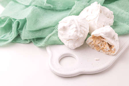 Homemade dessert. French meringues with nuts, pistachios and cup of coffee