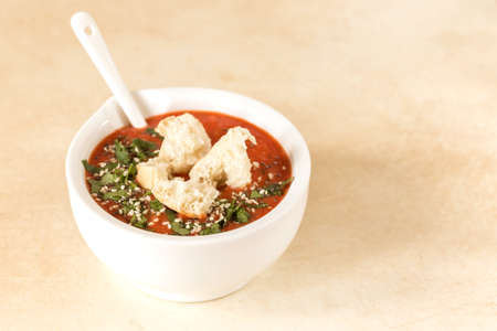 Italian pureed tomato soup gazpacho with croutons and fresh basil. Healthy food concept.