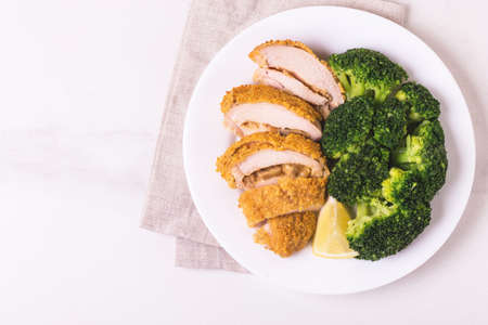Chicken grilled fillet filled with julienne, lemon and steamed broccoli. Healthy food, ketogenic diet. Keto/Paleo diet menu.の写真素材