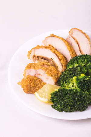 Chicken grilled fillet filled with julienne, lemon and steamed broccoli. Healthy food, ketogenic diet. Keto/Paleo diet menu.の写真素材