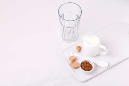 ingredients for dalgona coffee with milk and cane sugar. trendy South Korean cold summer drinkの写真素材