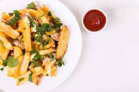 Canadian poutine french fries with brown gravy sauce, chicken and fresh cheese curds.