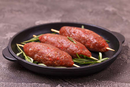 raw lula kebab, lyulya-kebab minced meat, shish kebab ready to cook with rosemary. Caucasian...
