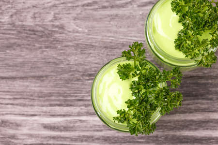 healthy detox green vegetable smoothie with avocado, cucumber, celery and thymeの写真素材