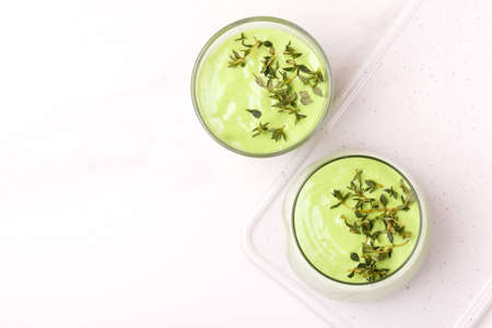healthy detox green vegetable smoothie with avocado, cucumber, celery and thyme
