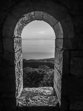 Stone window overlooking the seaの写真素材