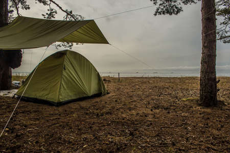 Tent on the sandy shore of the Gulf of Finland, Leningrad Region, Russiaの写真素材