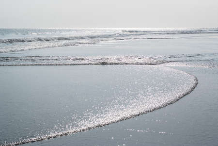 Ocean beach at low tide in daylightの写真素材