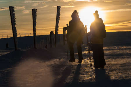 Tourists in the mountains on a winter sunset, Karkonosze, Krkonose, Czech Republicの写真素材