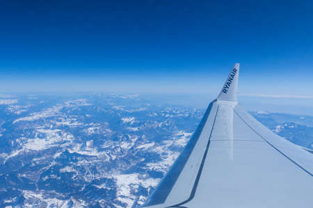Airplane wing over the Alps - Italy, March 13, 2022のeditorial素材