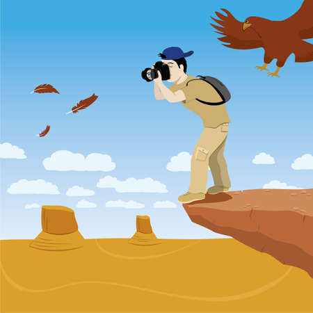 photographer standing on a rock cliffの写真素材