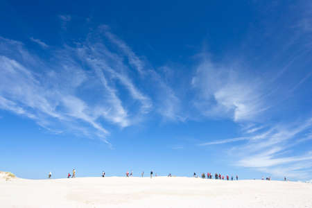 people walking in the big dune, Slowinski National Park, Polandの写真素材