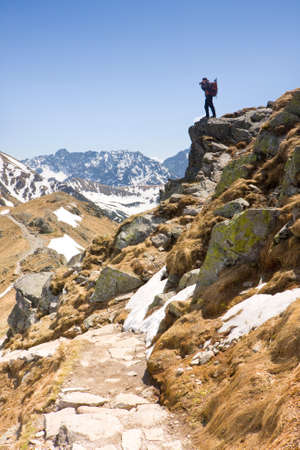 photographer in the mountains taking pictures, Tatra mountains, Polandの写真素材