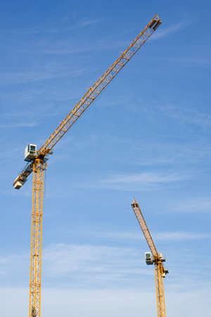 yellow hoisting cranesの写真素材