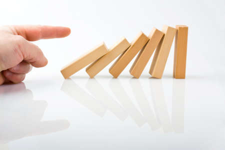 Hand and falling pieces on white background の写真素材