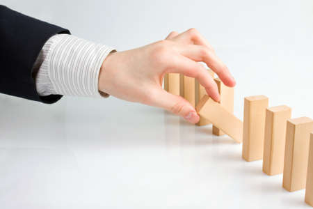 Concept for solution to a problem by stopping the domino effectの写真素材