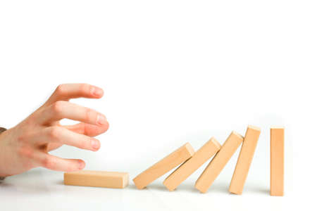 Concept for solution to a problem by stopping the domino effectの写真素材