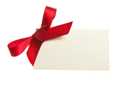 Blank gift tag tied with a bow of red satin ribbon  Isolated on white, with soft shadow の写真素材