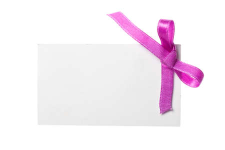 Blank gift tag tied with a bow of satin ribbon. Isolated on white, with soft shadow の写真素材