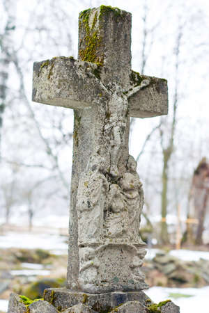 Marble cross on tomb at winter の写真素材
