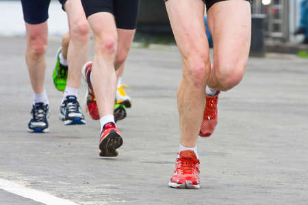 detail of the legs of runners at the start of a marathon race の写真素材