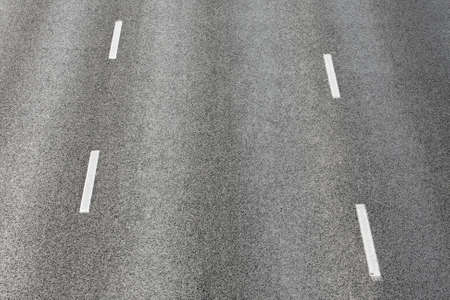 Road texture with two dashed white stripe の写真素材