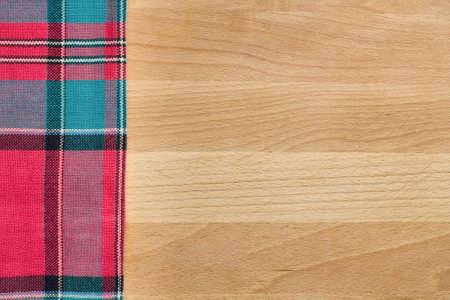 Background with tablecloth over wooden cutting boardの写真素材