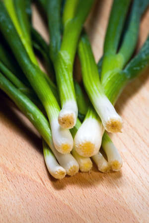 Young onion on cutting board background