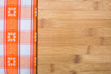 Background with tablecloth over wooden cutting board 