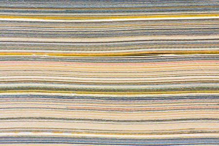 Macro closeup of pages in stack magazine, cardboard or cardstock.