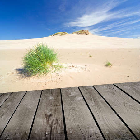 sunset on the beach and empty wooden deck table.の写真素材