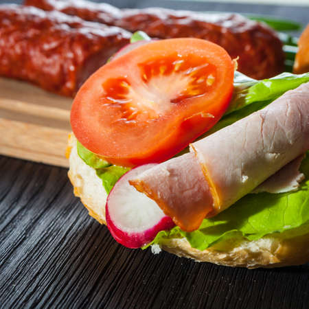 Ham, salad submarine sandwich from freshly cut baguetteの写真素材