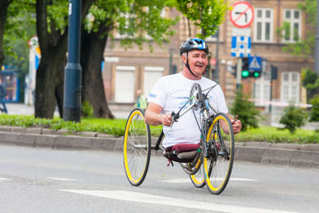 KRAKOW, POLAND - MAY 28 : Cracovia Marathon. Unidentified handicapped man in  marathon on a wheelchair on the city streets on May 18, 2014 in Krakow, POLAND のeditorial素材