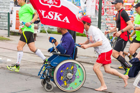 KRAKOW, POLAND - MAY 28 : Cracovia Marathon. Unidentified handicapped man in  marathon on a wheelchair on the city streets on May 18, 2014 in Krakow, POLAND のeditorial素材