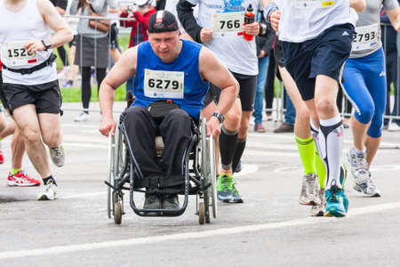 KRAKOW, POLAND - MAY 28 : Cracovia Marathon. Unidentified handicapped man in  marathon on a wheelchair on the city streets on May 18, 2014 in Krakow, POLAND のeditorial素材
