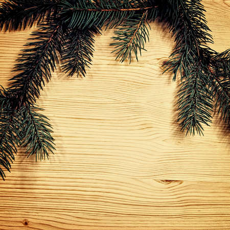 Christmas fir tree with decoration on a wooden board の写真素材