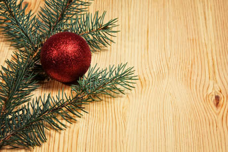 Christmas fir tree with decoration on a wooden board の写真素材