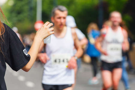 KRAKOW, POLAND - MAY 18 : Cracovia Marathon. Marathon runner picking up water at service point on May 18, 2014 in Krakow, POLANDのeditorial素材