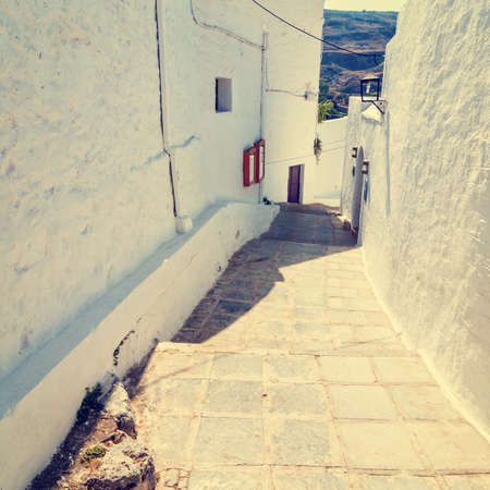 vintage photo of narrow street in Lindos. Rhodes, Greece の写真素材