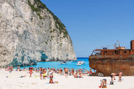 Zakynthos, Greece - June 01: Tourists at the Navagio Beach in Zakynthos, Greece on June 01, 2014. Navagio Beach is most popular attraction among tourists visiting the island of Zakynthos.のeditorial素材
