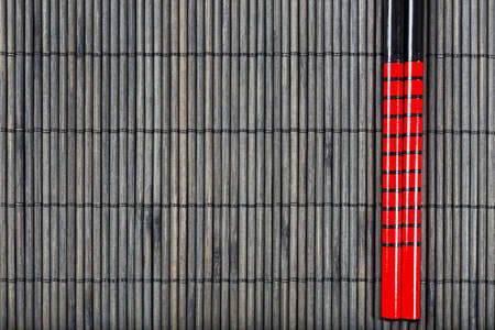 Two chopsticks on sushi mat backgroundの写真素材