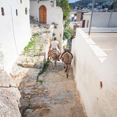 LINDOS, GREECE - JUNE 24: Unidentified tourists walking in historic town Lindos on June 24, 2008. Lindos is most popular turist destination located in the Rhodes Island, eastern Aegean Sea.のeditorial素材