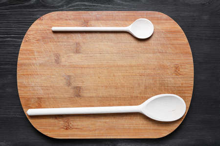 wooden cutlery on cutting boardの写真素材