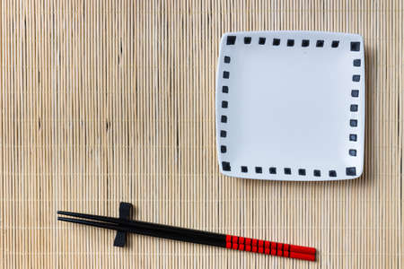 Two chopsticks on sushi mat backgroundの写真素材