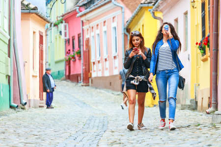 SIGHISOARA, ROMANIA - JULY 17: Unidentified tourists walking in historic town Sighisoara on July 17, 2014. City in which was born Vlad Tepes, Draculaのeditorial素材