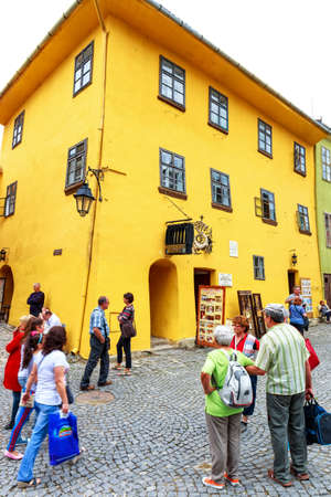 SIGHISOARA, ROMANIA - JULY 17: Unidentified tourists walking in historic town Sighisoara on July 17, 2014. City in which was born Vlad Tepes, Draculaのeditorial素材