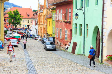 SIGHISOARA, ROMANIA - JULY 17: Unidentified tourists walking in historic town Sighisoara on July 17, 2014. City in which was born Vlad Tepes, Draculaのeditorial素材