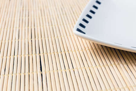 White plate on sushi mat backgroundの写真素材
